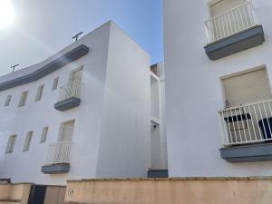 a white building with balconies on the side of it at Apartamento Gaviotas Sureñas in Tarifa