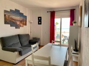 a living room with a couch and a table at Apartamento Gaviotas Sureñas in Tarifa
