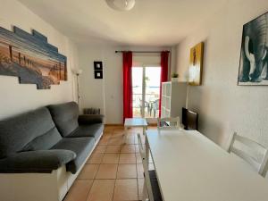 a living room with a couch and a table at Apartamento Gaviotas Sureñas in Tarifa