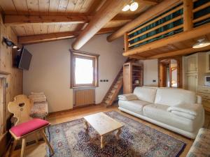 uma sala de estar com um sofá e um loft em Bait da Sandro em Livigno