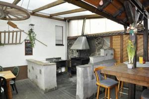 a large kitchen with a table and a stove at Hotel Lindenhof in Rödermark