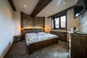 a bedroom with a bed in a room with a window at Resort Slunce in Harrachov