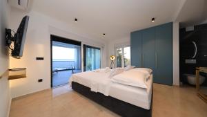 a bedroom with a large bed with a view of the ocean at AdAstra Apartments in Maslenica +65 photos