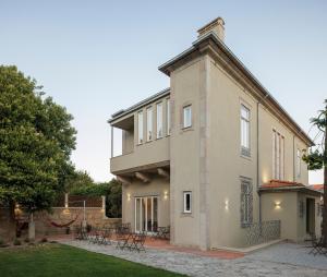 a large house with a patio and a yard at Casa Kala in Porto