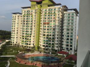 a large building with a pool in front of it at INFA - Muslim House @ Seroja Apartment, Johor Bahru in Johor Bahru