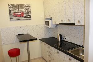 a small kitchen with a sink and a microwave at CIello Hostel in Lviv