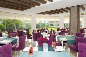 a restaurant with purple tables and purple chairs at Sun Club Side Hotel - All inclusive in Side