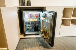 an open refrigerator in a corner of a kitchen at Victoria Deluxe Hotel in Chernivtsi