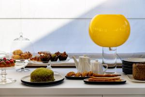 a buffet with plates of food and a glass of orange juice at Taodomus Small Boutique Hotel in Taormina