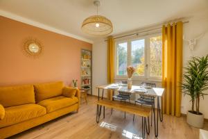 a living room with a yellow couch and a table at Le Boheme - MyCosyApart, Netflix in Annecy