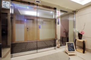 a glass elevator in a building with a sign at Jin Hua Hotel in Luodong