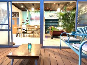 a porch with a table and a dining room at Sotoura Beach House Shimoda - Less thank 1 min walk to Sotoura Beach! in Shimoda
