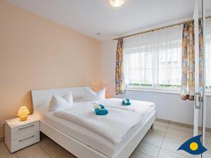 Ein Bett oder Betten in einem Zimmer der Unterkunft Ferienwohnung (-haus) Whg. 01 Gartenstraße