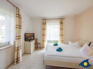 Ein Bett oder Betten in einem Zimmer der Unterkunft Ferienwohnung (-haus) Whg. 01 Gartenstraße