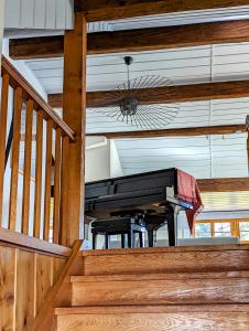 a piano sitting on the stairs of a house at Domaine de la Crausaz in Grandvaux