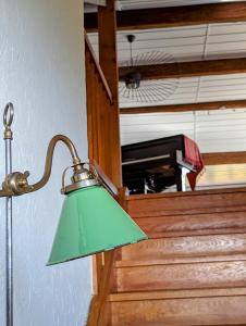 a green lamp sitting in front of a staircase at Domaine de la Crausaz in Grandvaux