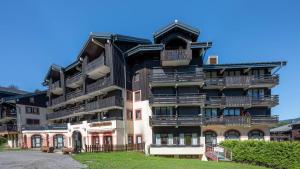 a building with balconies on the side of it at Grand Morillon - 104 - Montagne Belle Vue Studio 4 in Morillon
