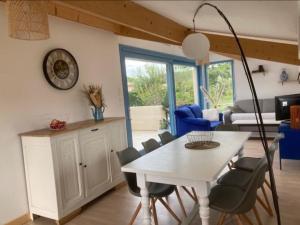Una cocina y un comedor con mesa y sillas. en Gîte Le vallon des vignes, en Vallon-Pont-dʼArc