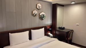 Postel nebo postele na pokoji v ubytování Sun Sweet Hotel