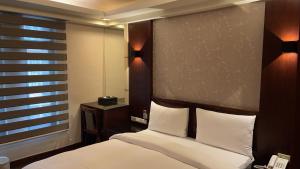 Postel nebo postele na pokoji v ubytování Sun Sweet Hotel