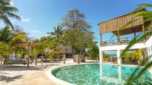 a pool at a resort with a pavilion at The Mida Creek Hotel in Watamu