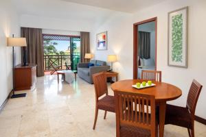 a living room with a table and chairs and a couch at Holiday Inn Resort Batam by IHG in Sekupang