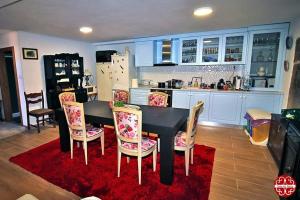a kitchen with a black table and chairs and a kitchen with blue cabinets at Casa dos Ferros in Freixiel