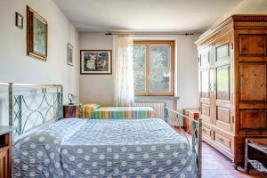 1 dormitorio con cama y ventana en Villa Verde, en Lucignano