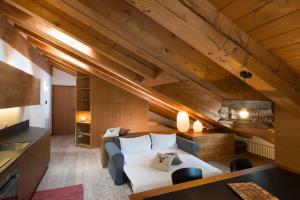 a bedroom with a bed in a room with wooden ceilings at Appartamento Jardin des Alpes. in La Thuile