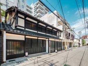 an old building on the side of a street at Kanata Machiya House in Kanazawa