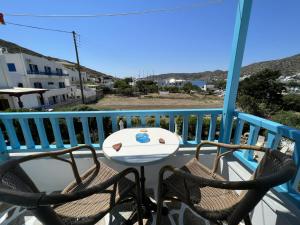 a table and chairs on a balcony with a view at Georgia Studios in Katapola