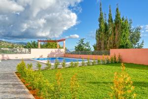 a backyard with a swimming pool and a gazebo at Villa Mendonca, a Home in Madeira in Canhas