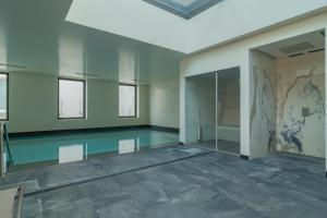 an empty room with a swimming pool in a building at Liberdade Garden & Indoor Pool by LovelyStay in Lisbon