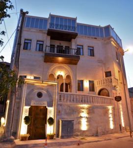 a large white building with a balcony on top of it at La Perla Cave Cappadocia in Urgup