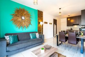 a living room with a couch and a dining room at Araminta 2-Bedroom Apartment in Larnaca in Larnaka