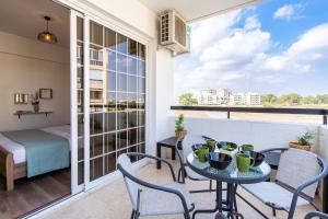 a balcony with a table and chairs and a bed at Araminta 2-Bedroom Apartment in Larnaca in Larnaka