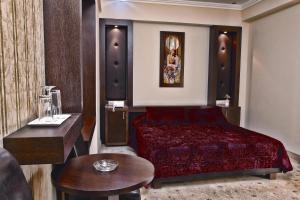 a hotel room with a bed and a table at Phaidon Hotel & Spa in Florina