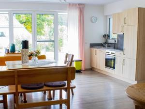 a kitchen with a table and a dining room at Ferienwohnung Gute Zeit - Apartment 2 in Bleialf