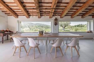 a large dining room with a large wooden table and chairs at Villa Aga - Homelike Villas in Cingoli