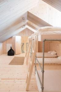 a room with two bunk beds in a attic at The Longhouse at Lista in Farsund
