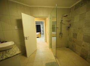 a bathroom with a shower and a sink at Riverside Residence - BEAU VALLON in Beau Vallon