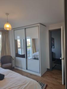 a bedroom with a sliding glass door with a bed at Harbour View Townhouse in Portrush