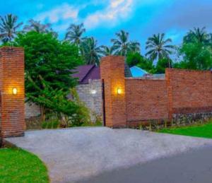 a brick wall with lights on top of it at Tiffany Garden in Mangsit