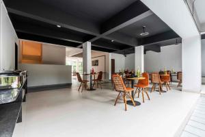 a dining room with a table and chairs at Le Papillon By Bay Hotels in Lonavala