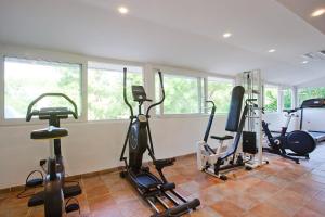 a gym with several treadmills and exercise bikes at Hotel Cala Sant Vicenç - Adults Only in Cala de Sant Vicenc
