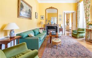 a living room with a blue couch and a fireplace at 10 Bedroom Cozy Home In Allonne in Beauvais