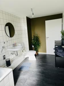 a bathroom with a toilet and a sink at Shadow Sleep in Schonungen