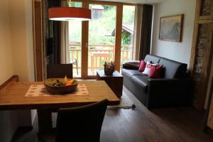 een woonkamer met een tafel en een bank bij Landhaus Lenauer in Lermoos