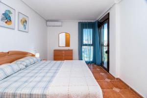 a bedroom with a large bed and a window at Espanatour PLAYA FLAMENCA in Orihuela Costa +17 photos