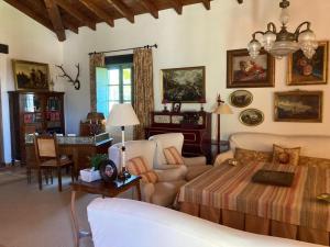 a living room with a bed and a table at El Encinar, Country House in Alanís, Andalusia in El Encinar